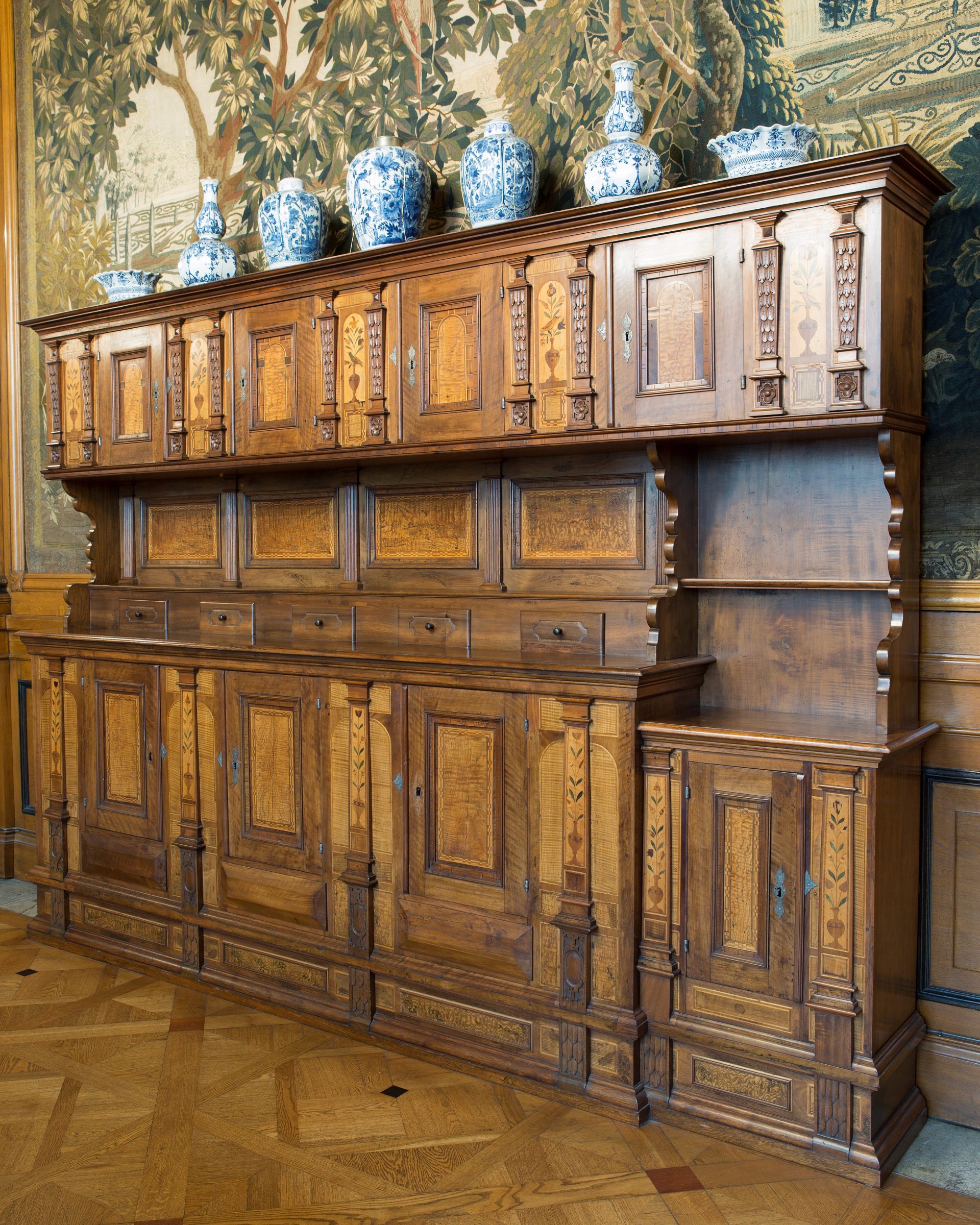 A wooden cabinet with several doors.