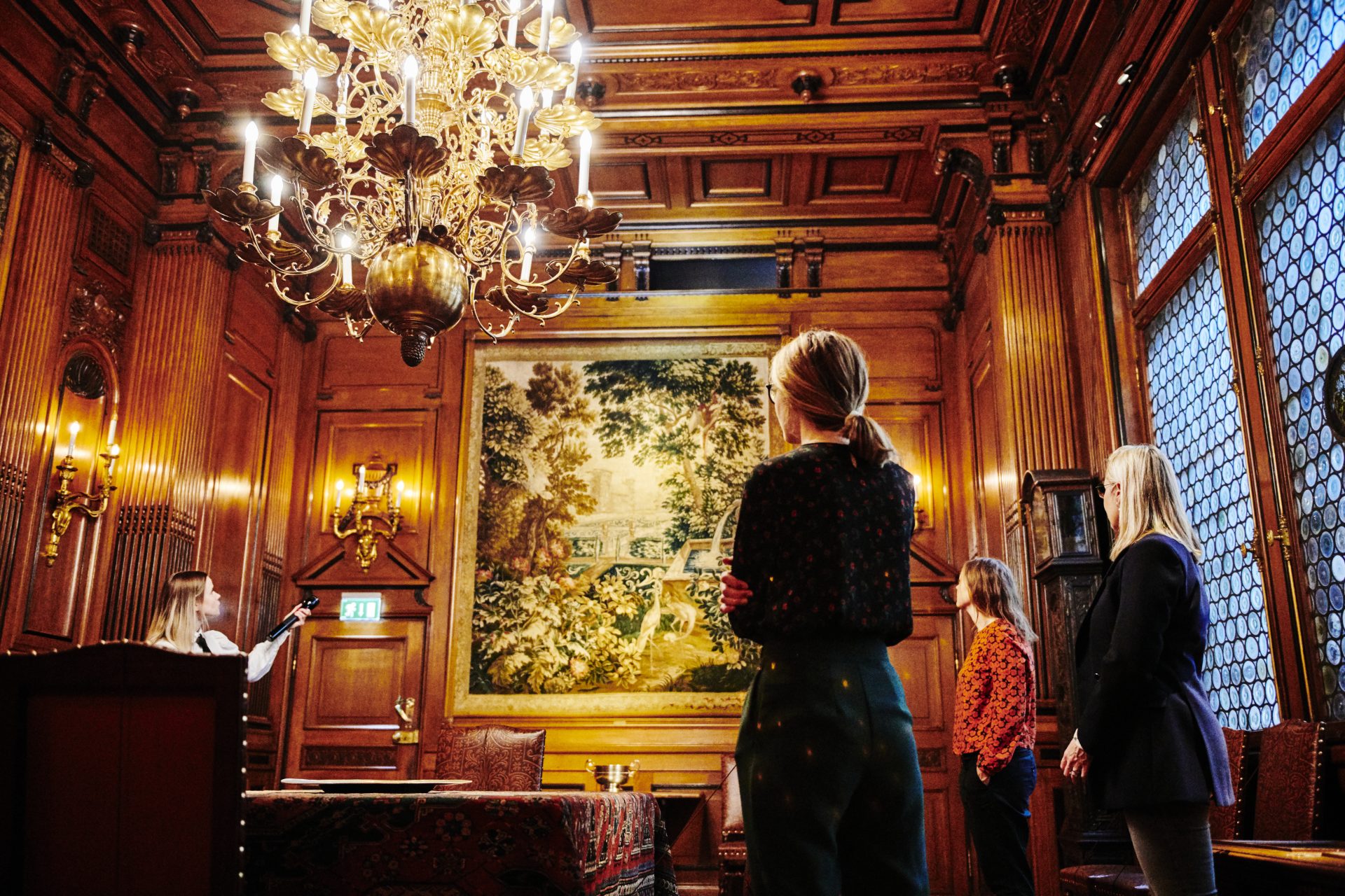 a museum guide shows around visitors in the museum.