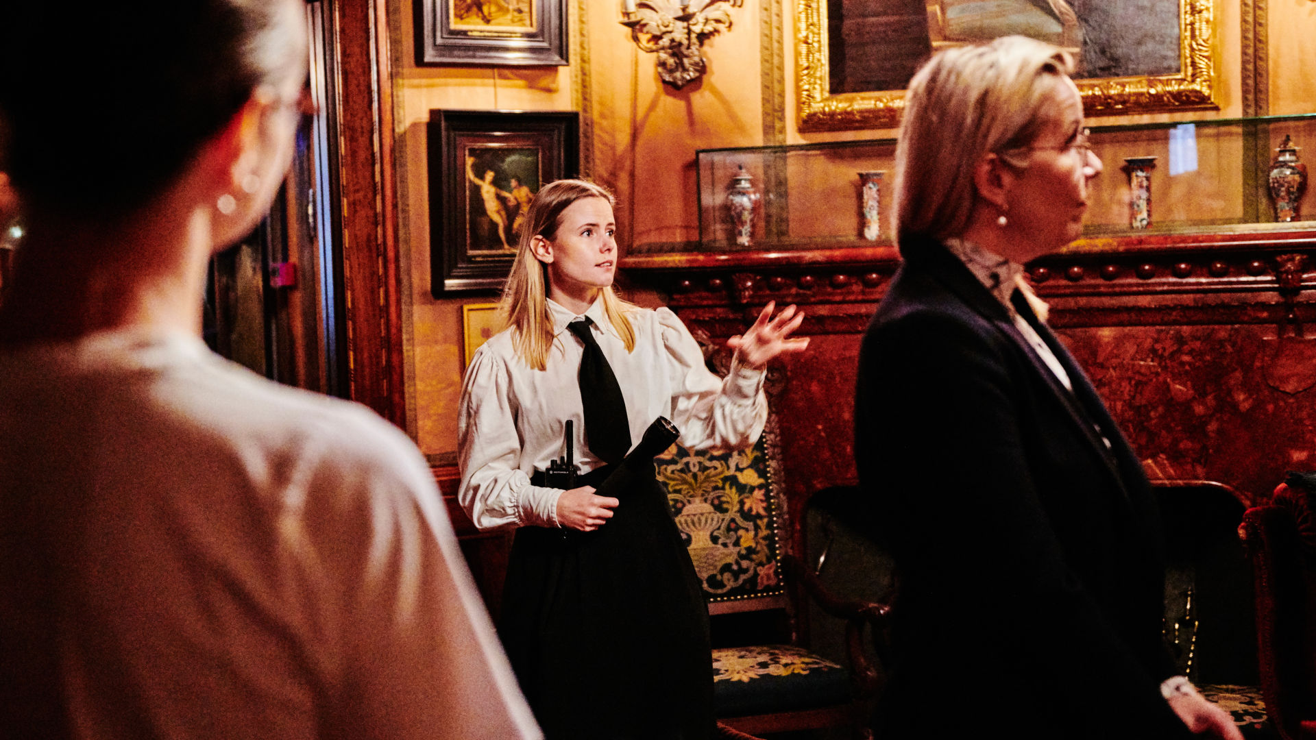 A guide shows a group of visitors around in the museum