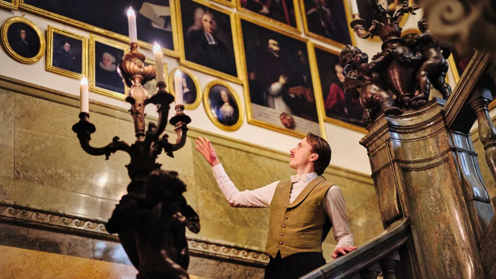 A guide shows people around the museum.